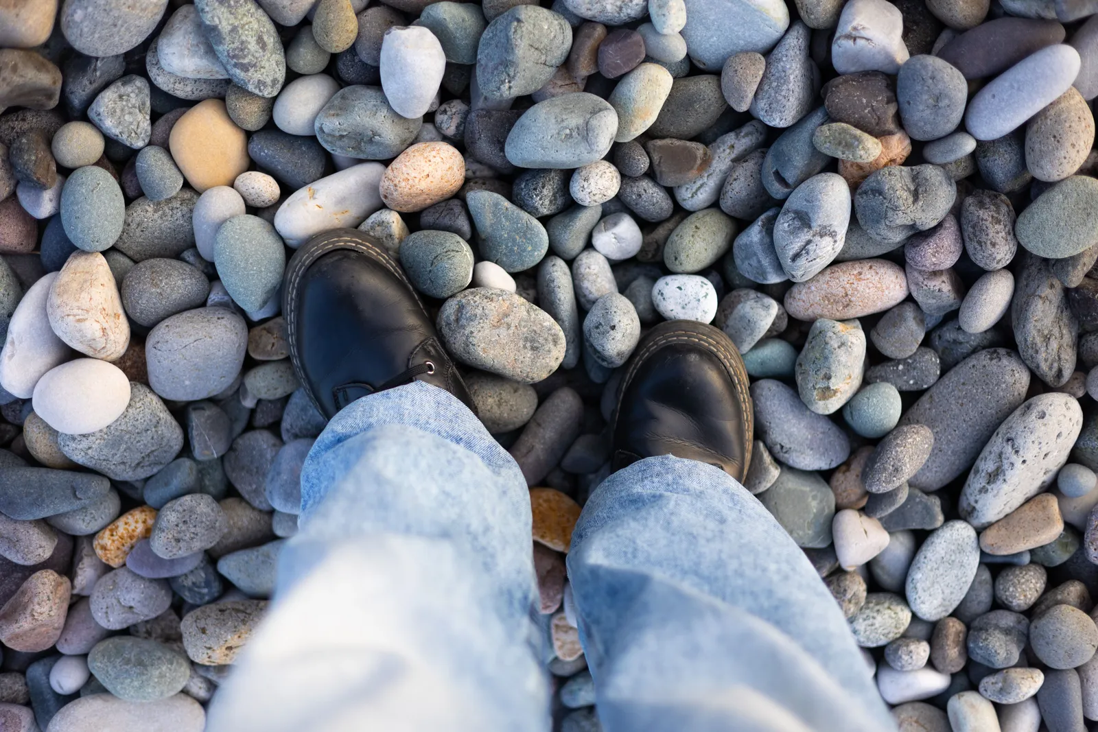 Walking boots standing on the pebbles of a Black Sea beach in Georgia