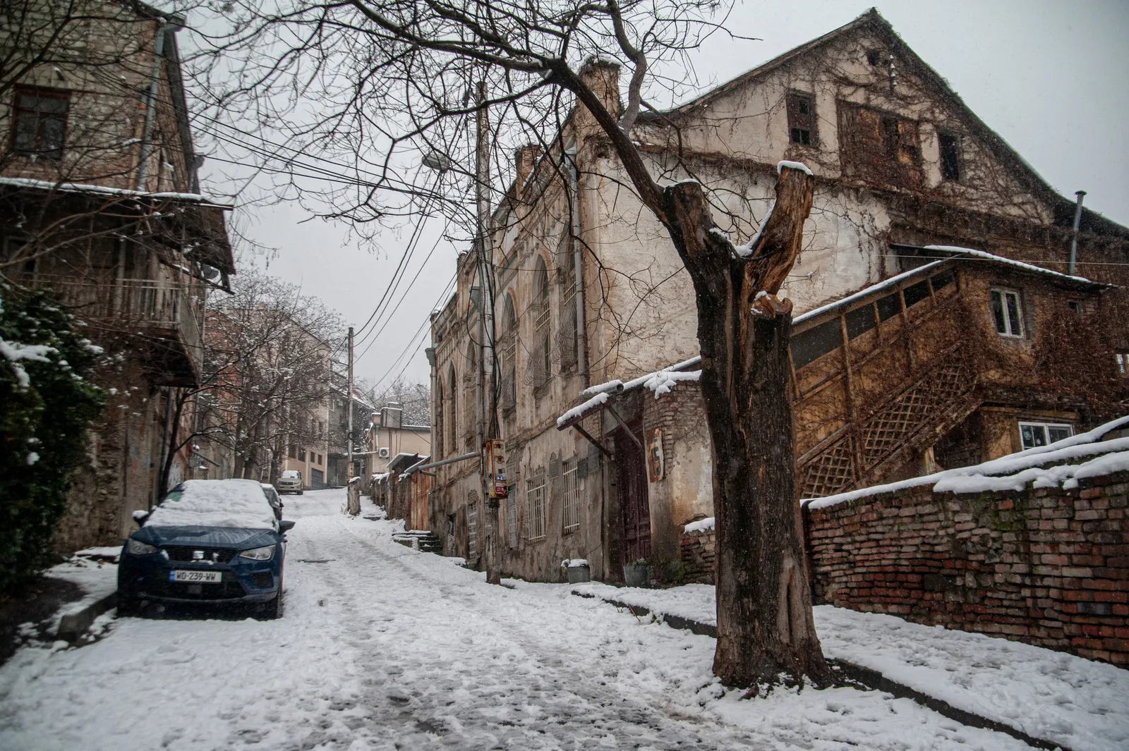 Snowy winter street lined with historic buildings