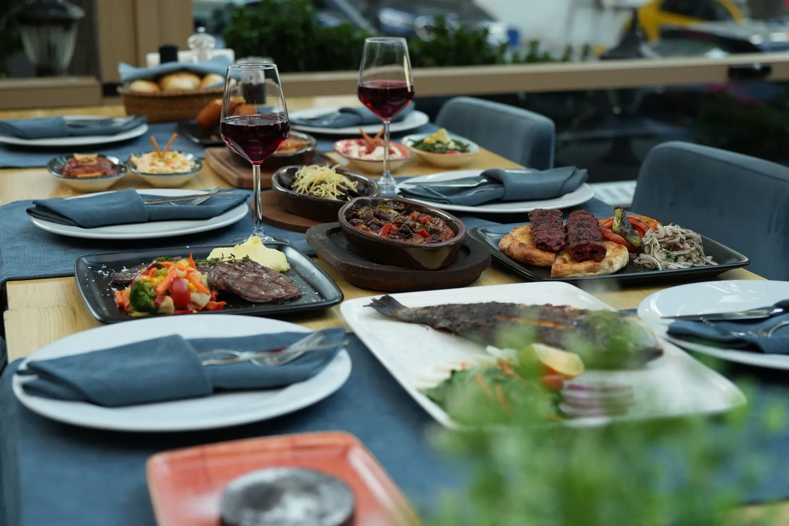 Long table covered with Georgian dishes and wine glasses at a feast