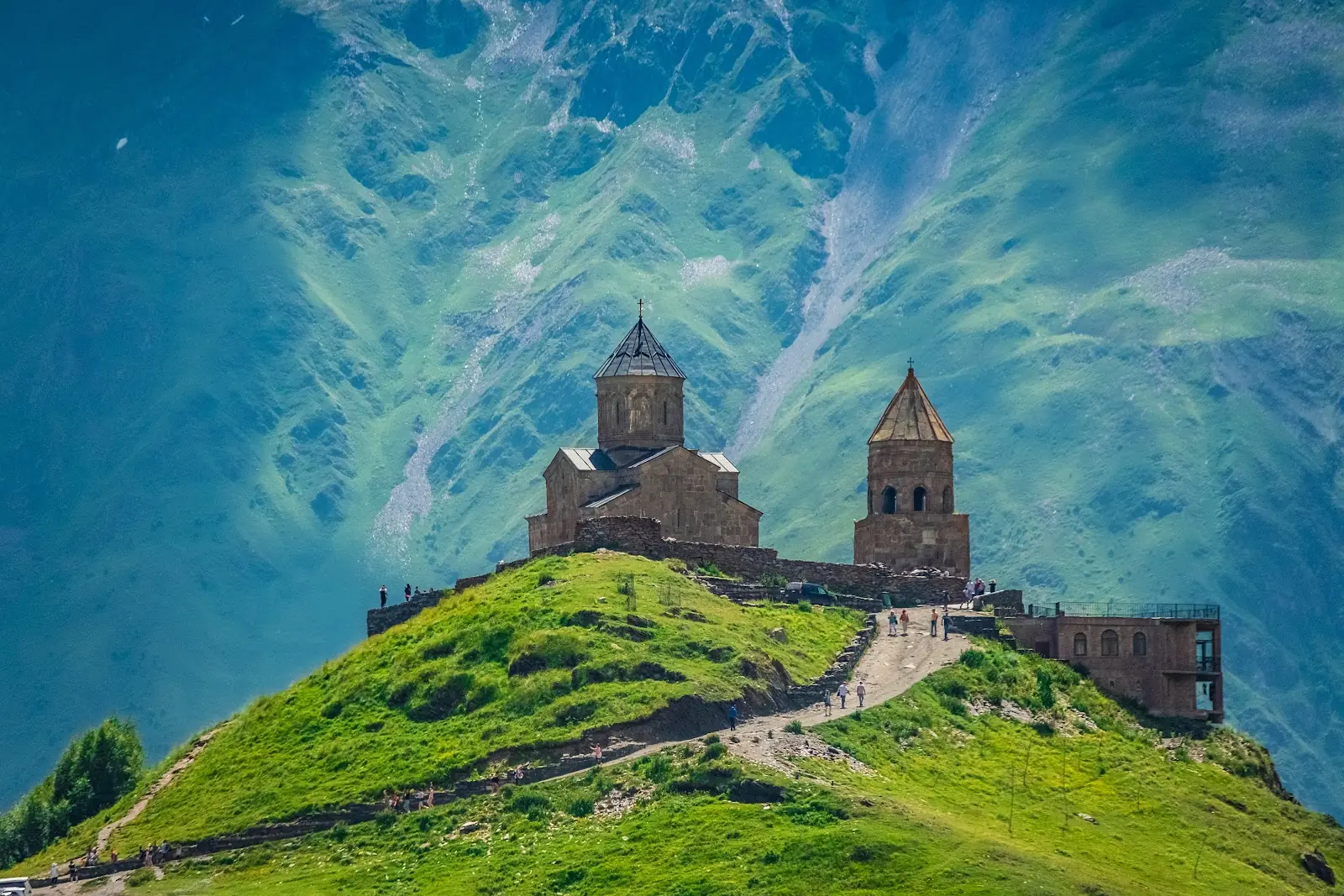 Gergeti Trinity Church beneath Mount Kazbek in Kazbegi, Georgia, on a clear mountain day