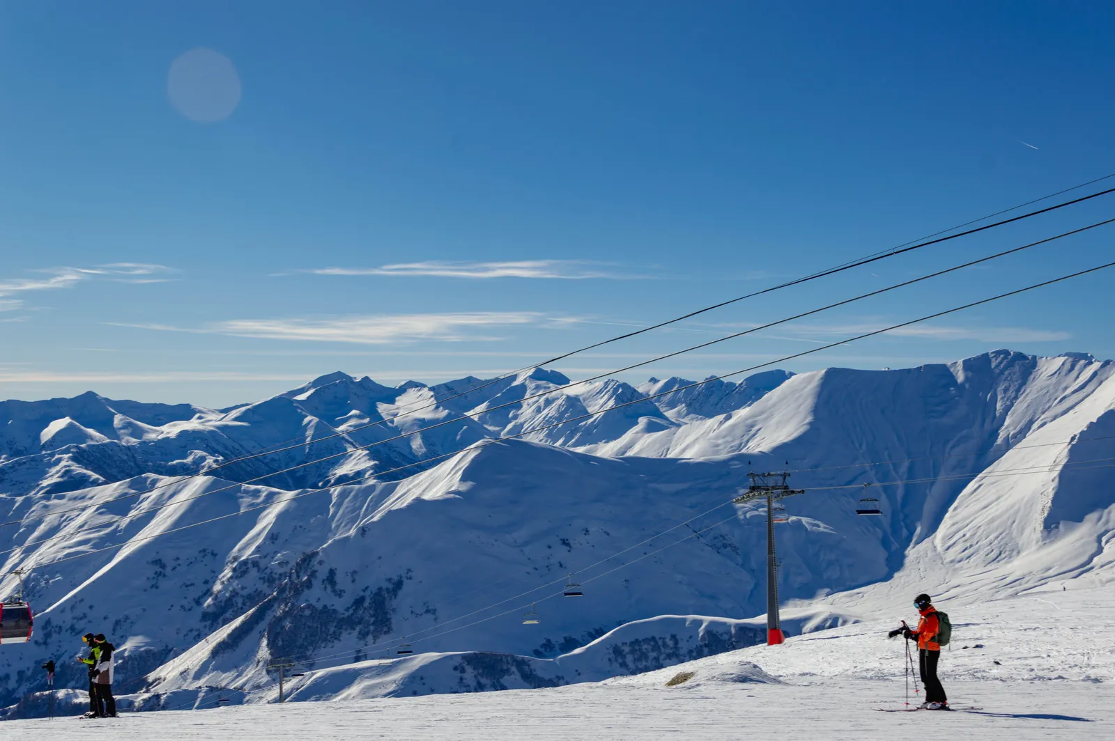 Open snow slopes and lift pylons above the tree line at the Gudauri ski resort in Georgia