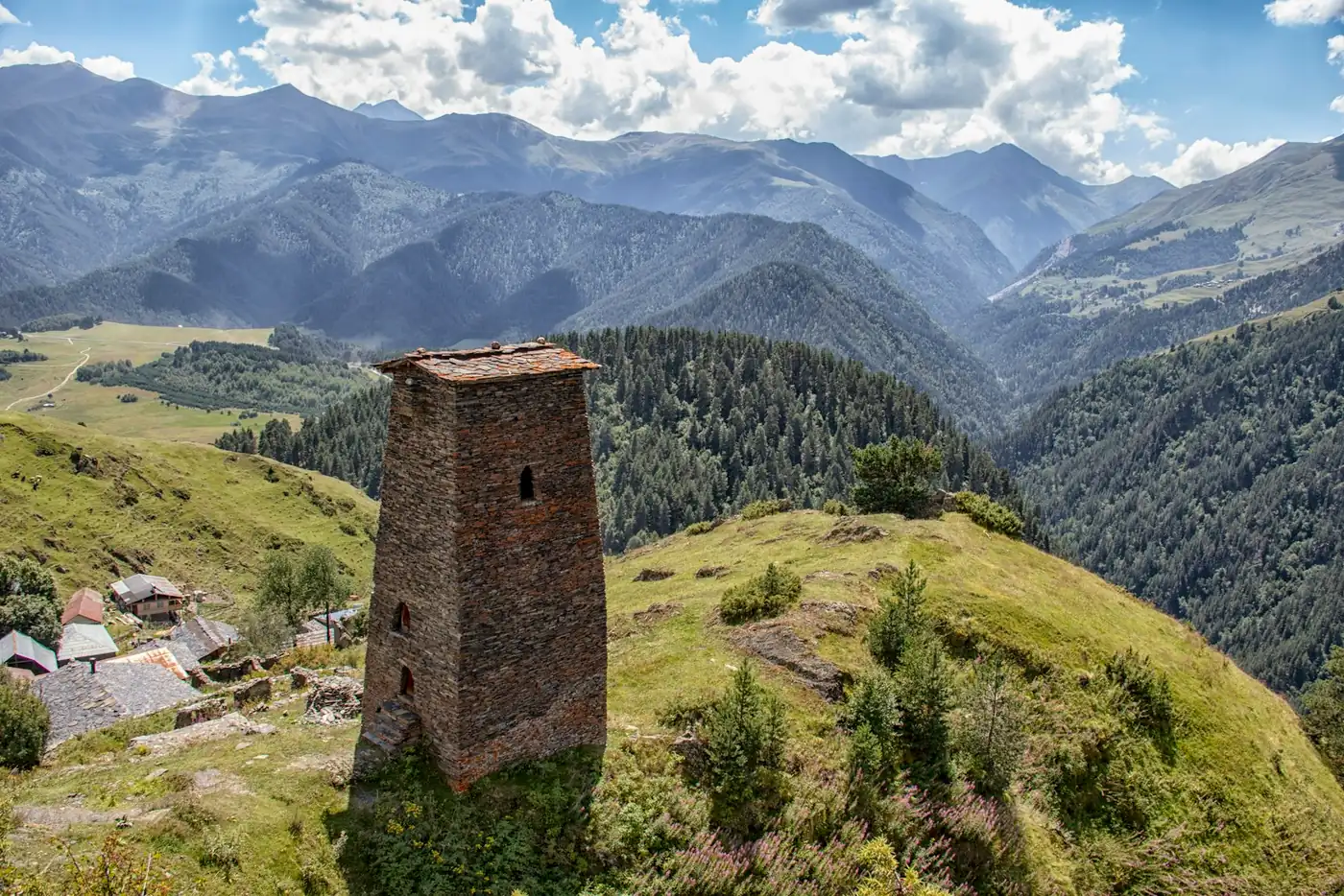 A stone defensive tower of the Keselo group on the ridge above Omalo in Tusheti, with the valley falling away behind it