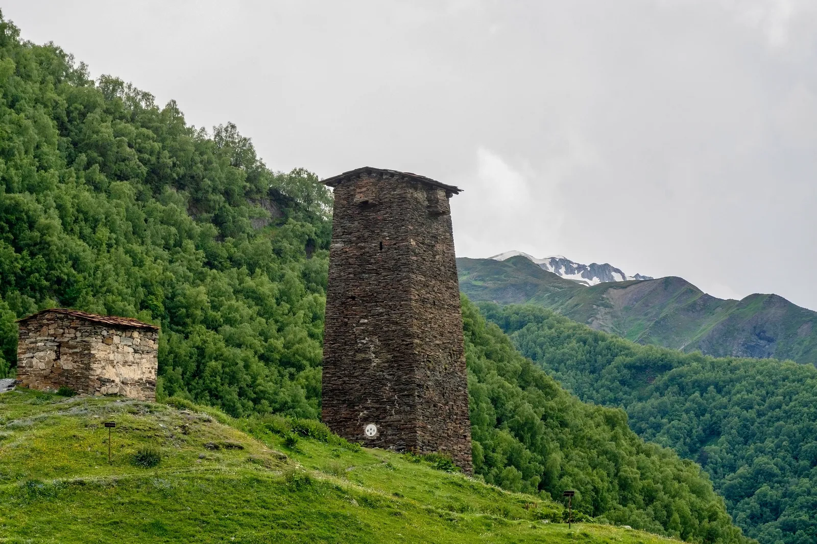 A historic stone tower in Mestia, Svaneti, below the mountains