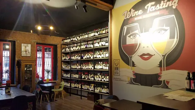 A room with a full wall of wine shelves and a large mural of a woman with wine glasses