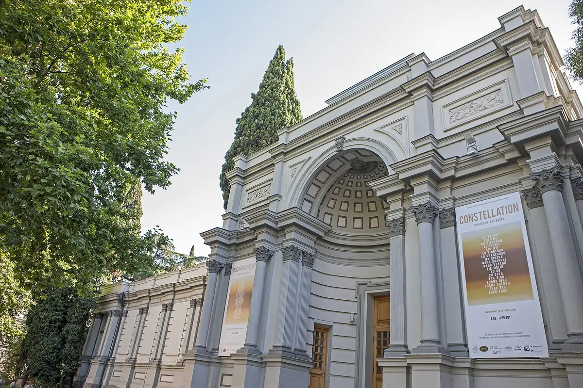 A classical gallery building with columns and banners