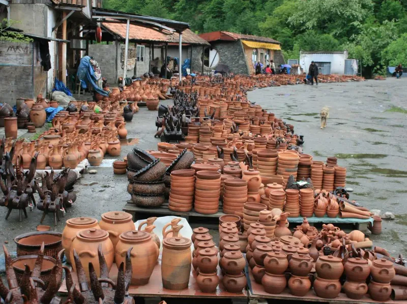 Hundreds of brown clay pots and jars laid out along the roadside in front of the stalls of the Shrosha pottery market