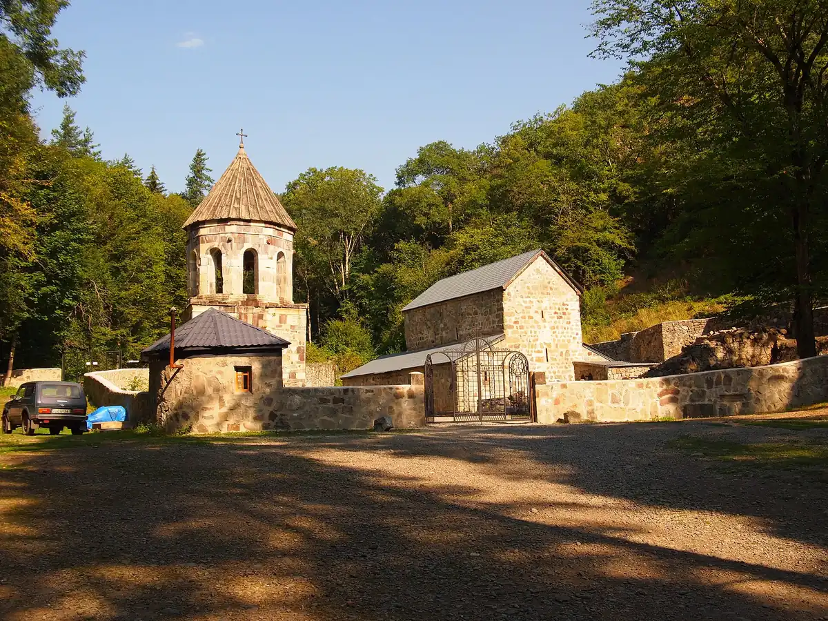 A stone monastery among trees in the forest