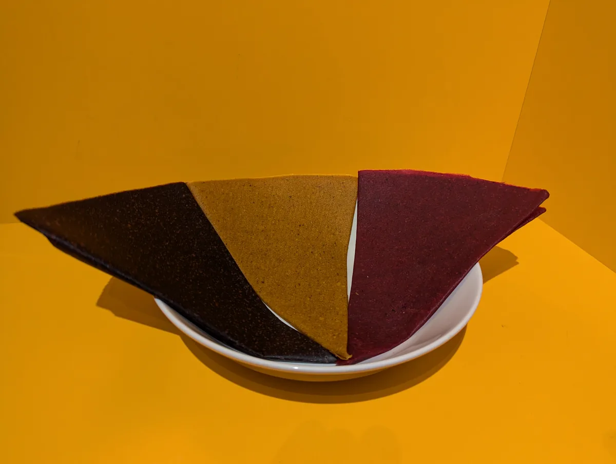 Rolled sheets of fruit confection on a plate