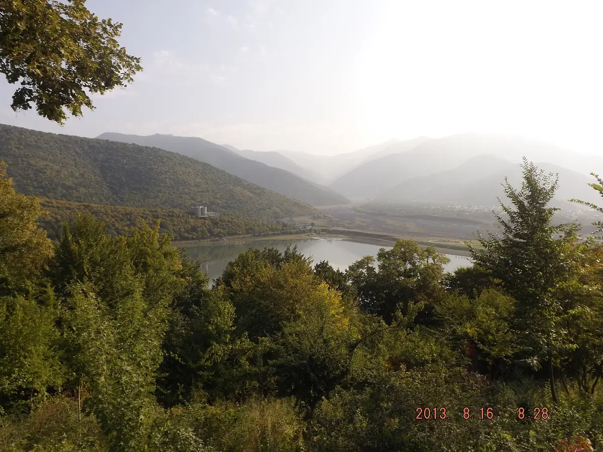 A green valley in morning mist with a river