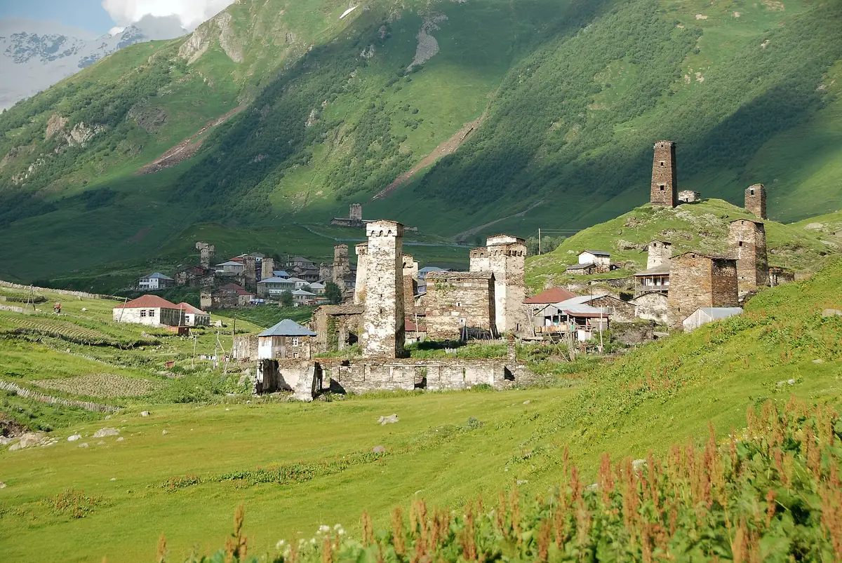 A village of towers on a green mountain slope