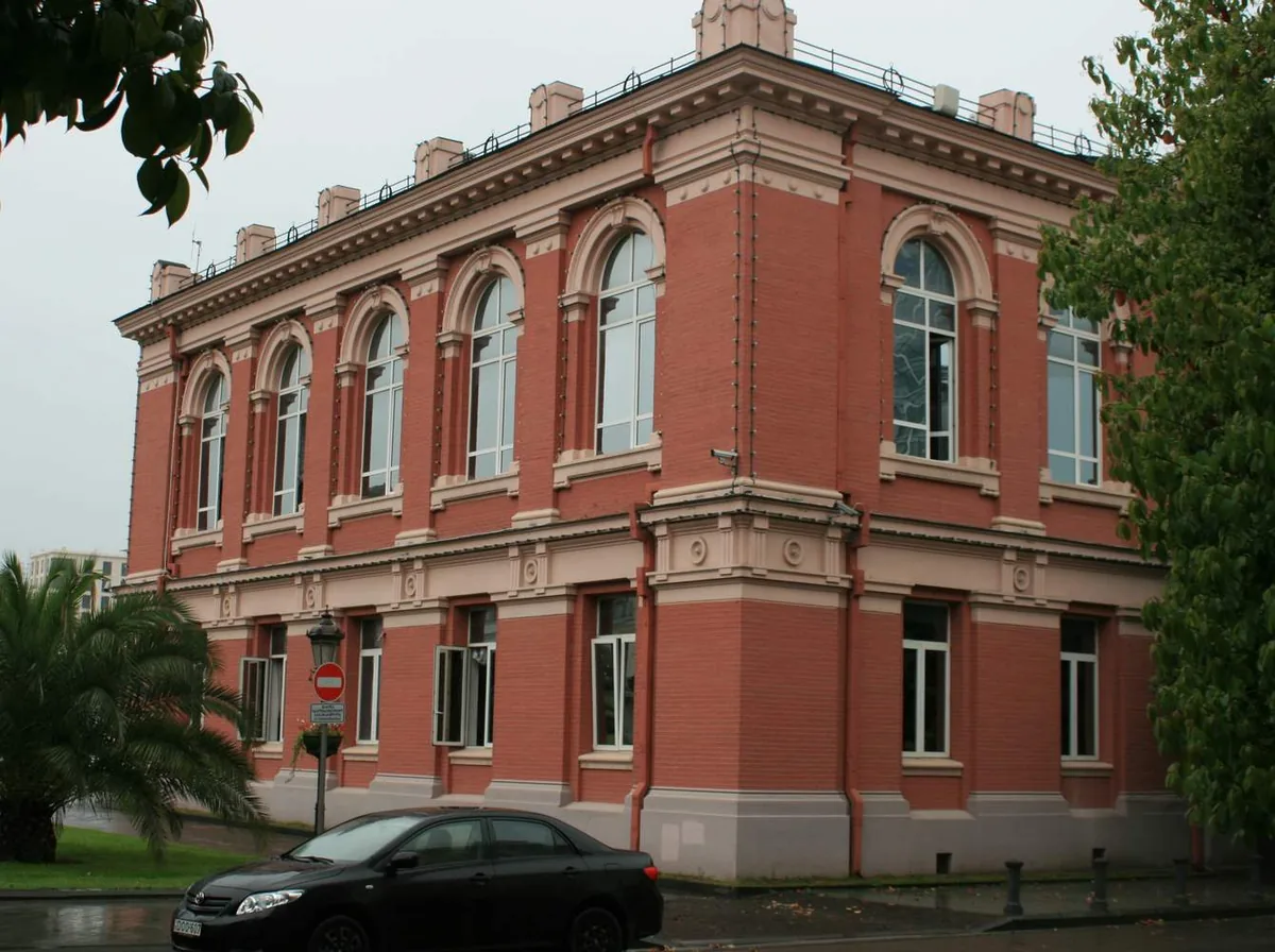 A red brick mansion with arched windows
