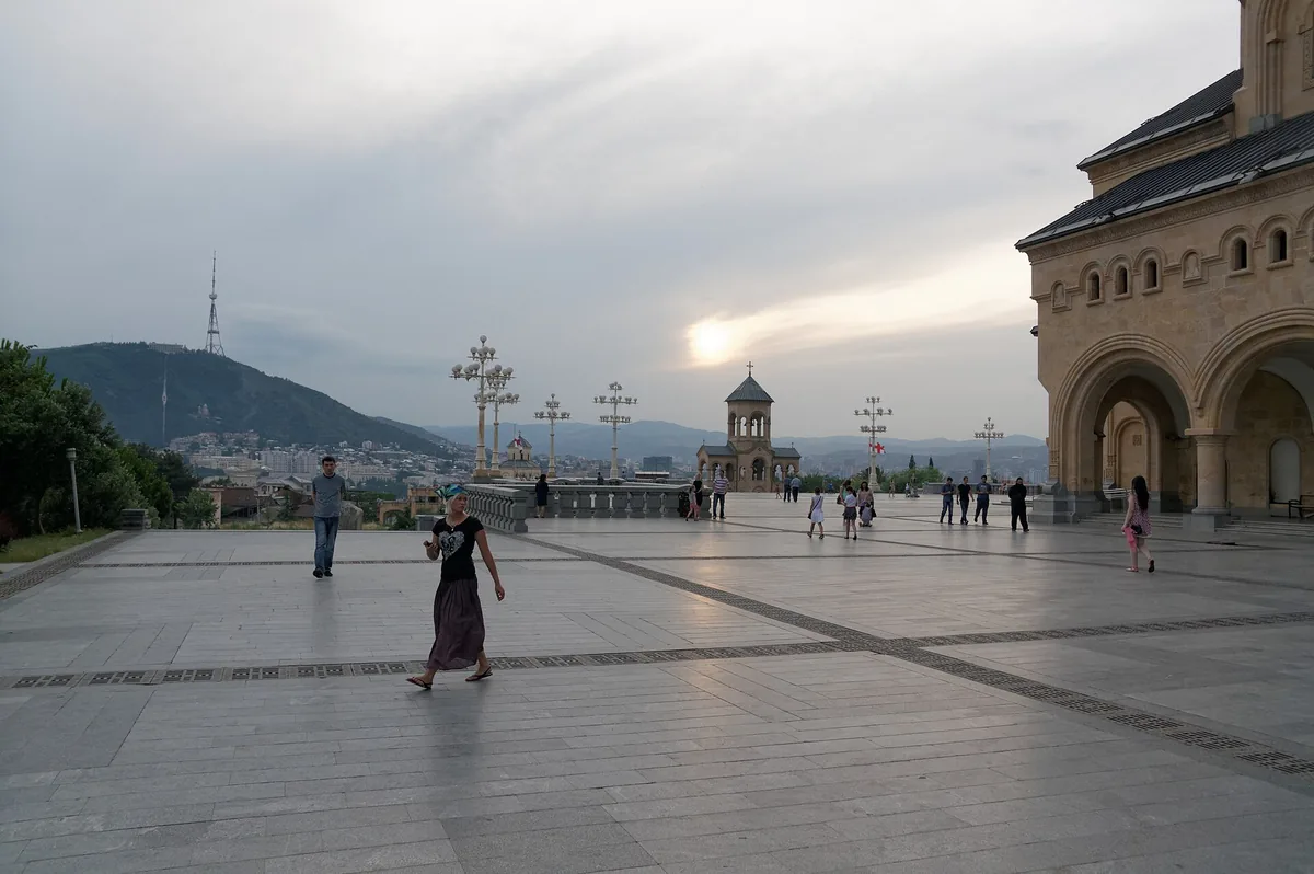 A paved cathedral forecourt with visitors