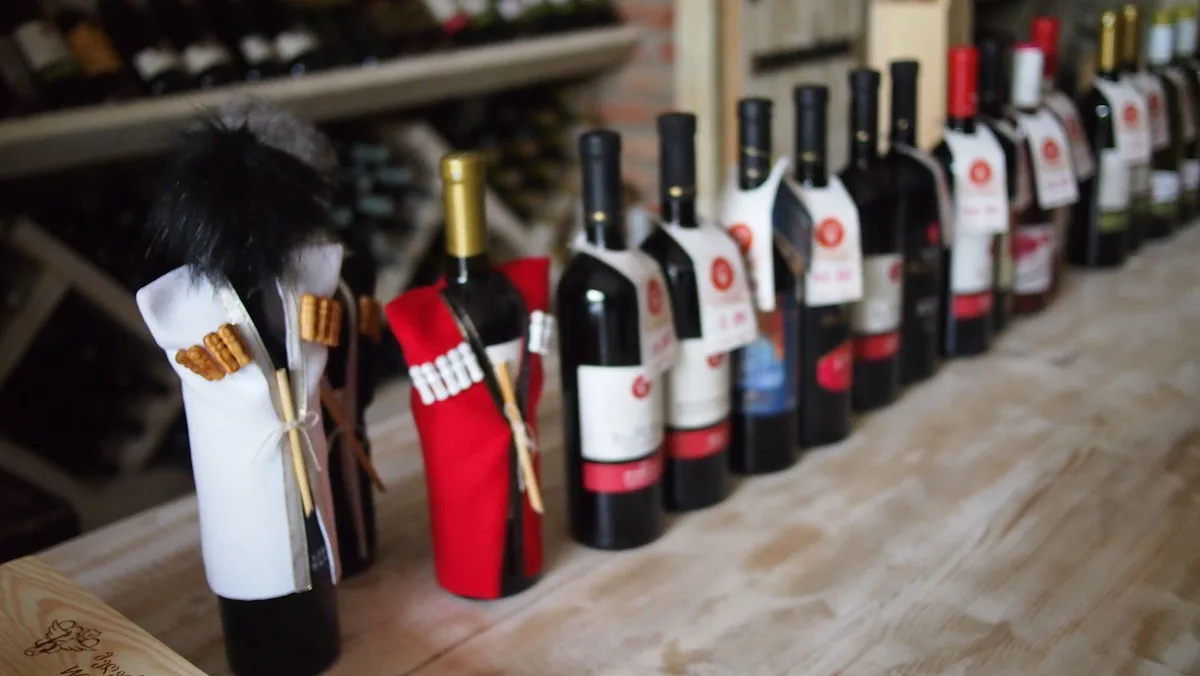 Wine bottles dressed in traditional costume on a shelf