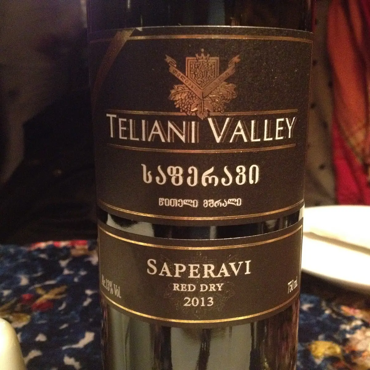 A close up of a red wine bottle on a table