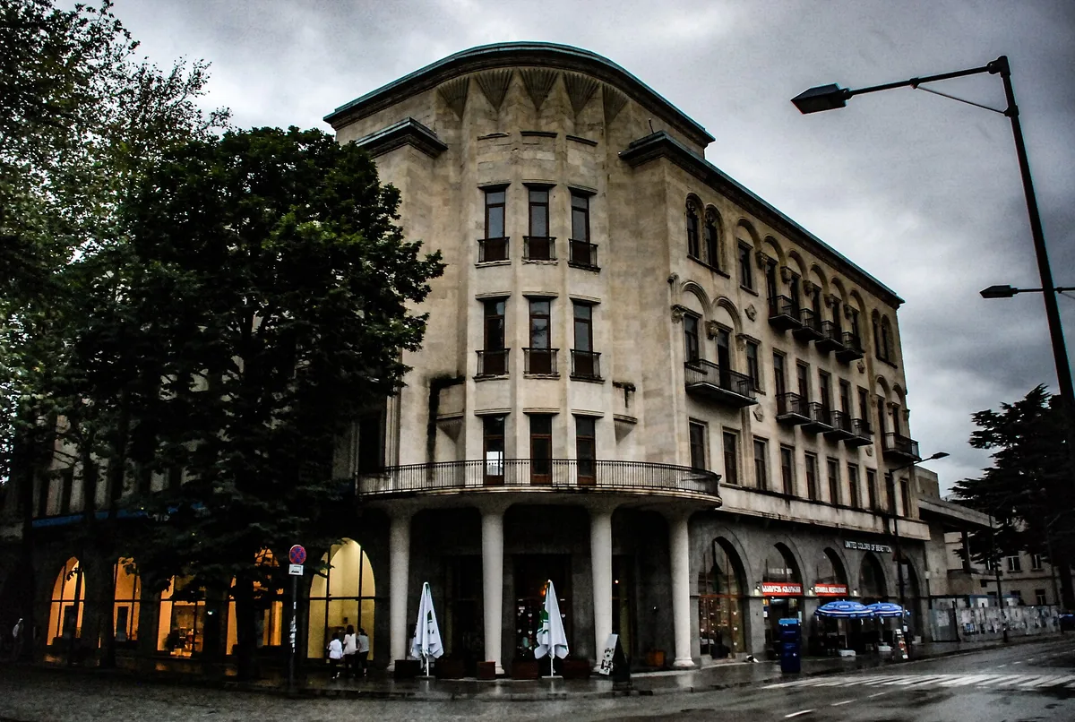 A street with older buildings and parasols