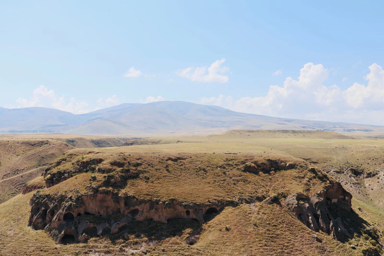 Dry eroded badlands under a wide open sky in the semi desert of eastern Georgia