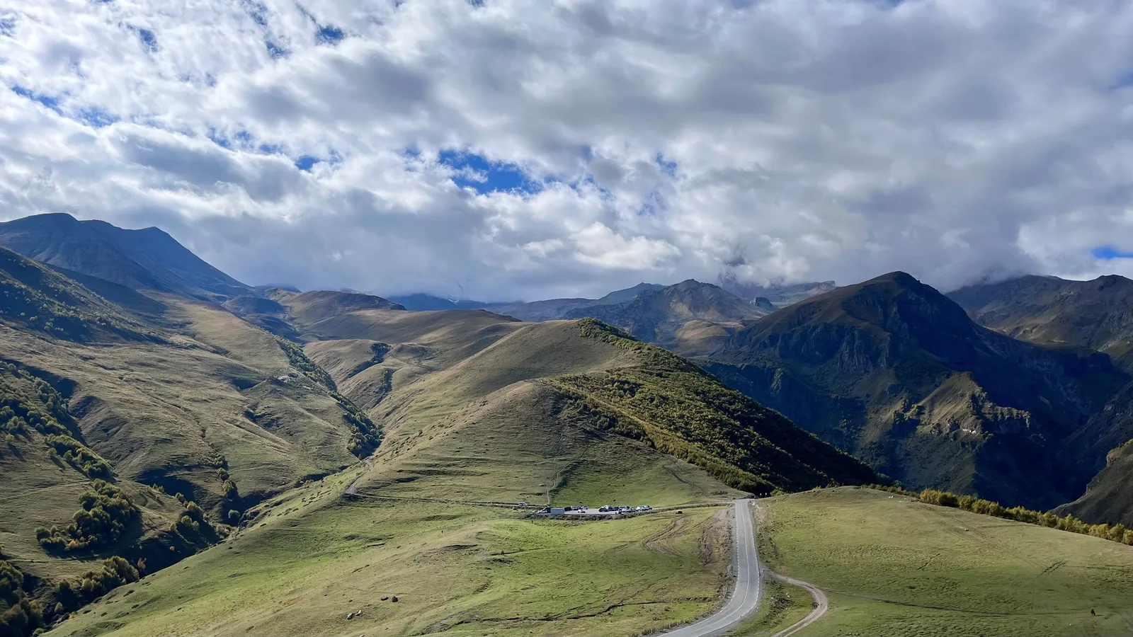 Valley road with mountains on both sides in the high Caucasus